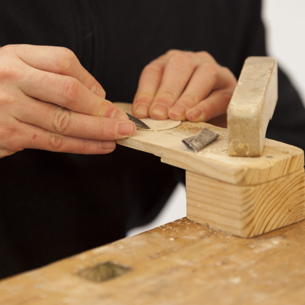 A Cymatic Organ — hand-shaped wooden form positioned near the headphone driver