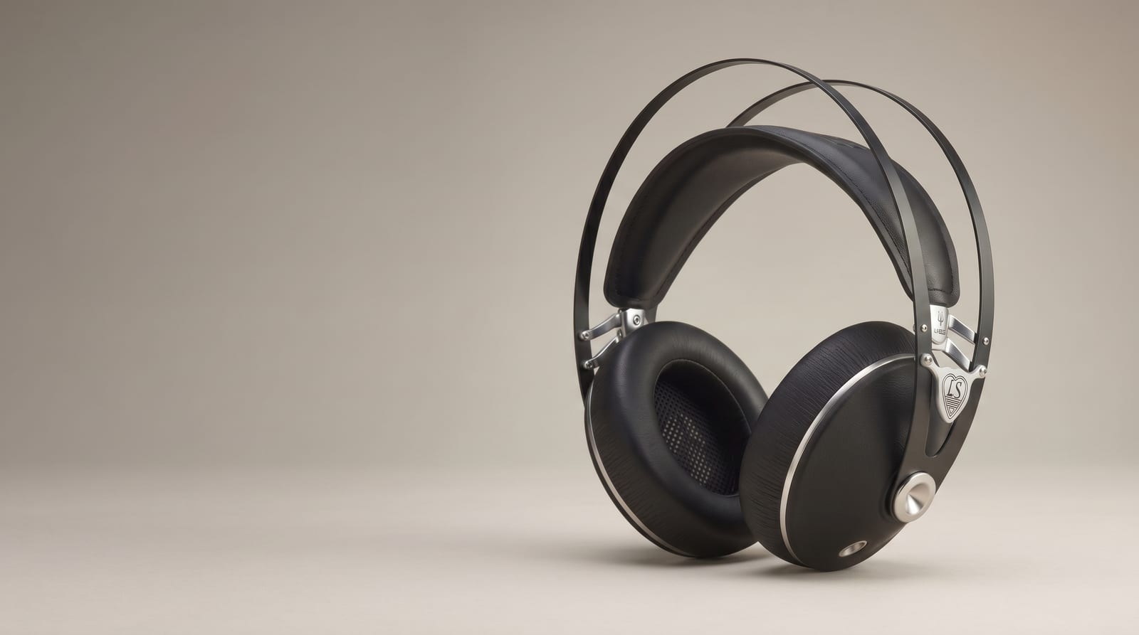 The Lautsänger Journey — black over-ear headphones on a warm taupe studio background