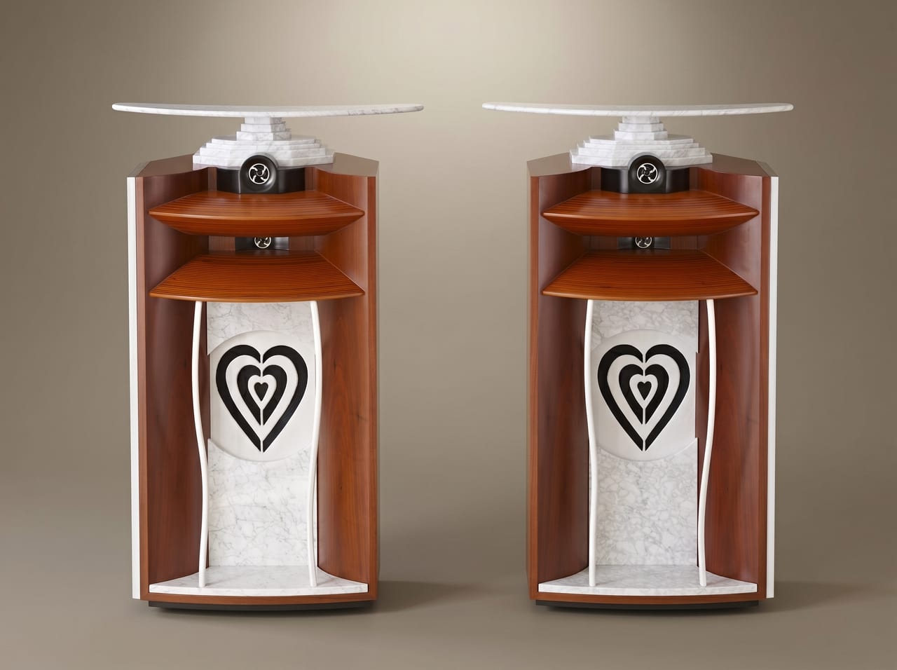 The Lautsänger Scala — paired speakers in Carrara marble, granite, and tonewood, each with a carved triple-heart marble baffle